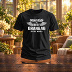 The Best Grandad In The World wings T-shirt in black on a wooden stand in a sunny garden room - gift for grandad