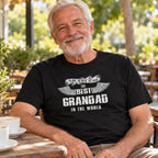 The Best Grandad In The World wings T-shirt in black - smiling grandad at a café table with a cup of coffee, gift for grandad