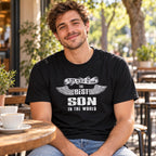 The Best Son In The World wings T-shirt in black - smiling son at a café table with a cup of coffee, gift for son from his parents