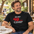 The First 40 Years of Childhood T-shirt in black with a red 40 - smiling man at a café table with coffee, 40th birthday gift