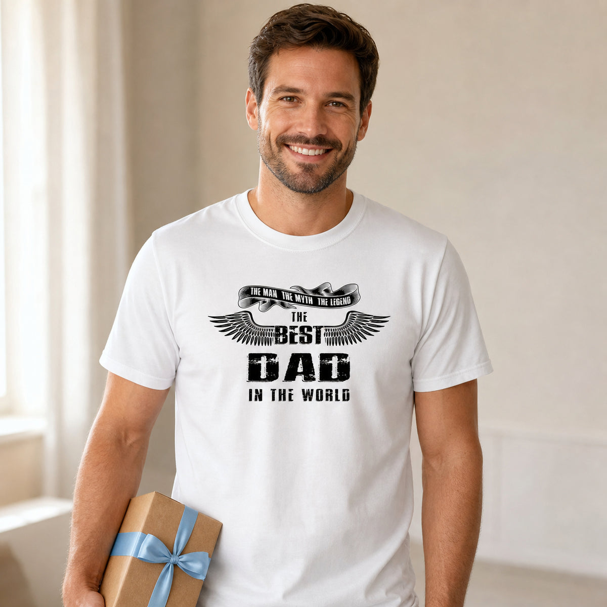The Best Dad in the World wings t-shirt in white - dad holding a present at home, Father's Day gift