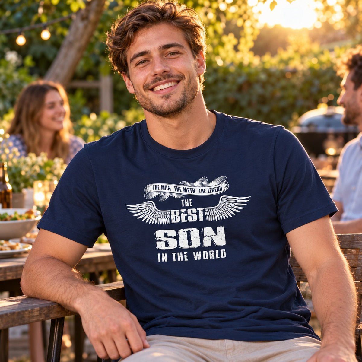 The Best Son In The World wings T-shirt in navy - son relaxing at an evening garden party with friends, gift for son from his parents