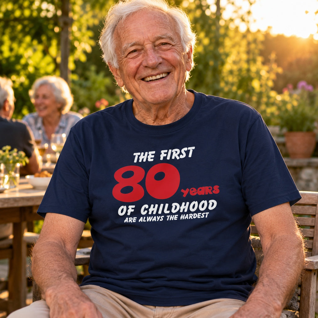 The First 80 Years of Childhood T-shirt in navy with a red 80 - smiling grandad at a garden party, funny 80th birthday shirt