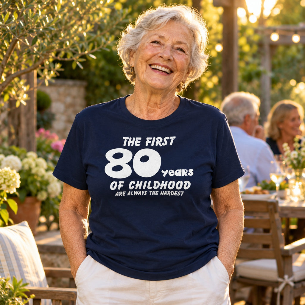 The First 80 Years of Childhood T-shirt in navy - woman at an evening garden party with friends, funny 80th birthday shirt